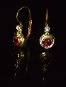 18K yellow gold 4 1/2 mm  faceted ruby French hook earrings with 0,10 ct total weight diamond accent